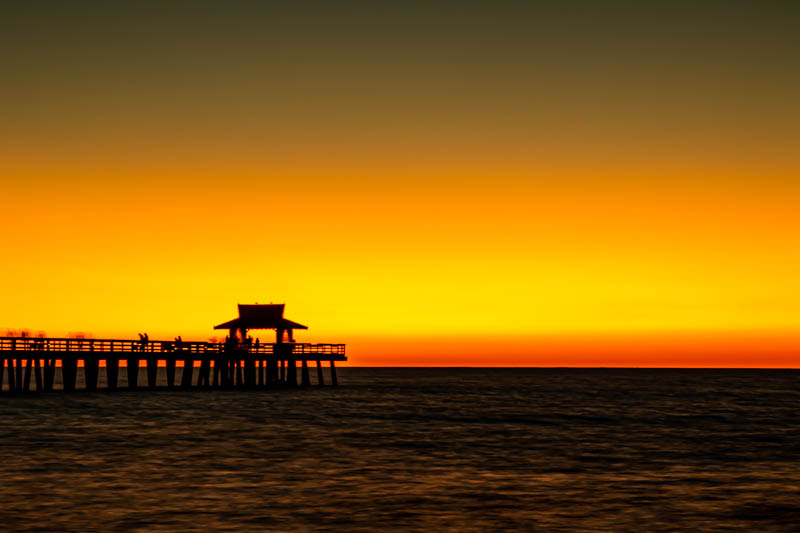 Deep pink and orange sunset over the Gulf from Naples, Florida
